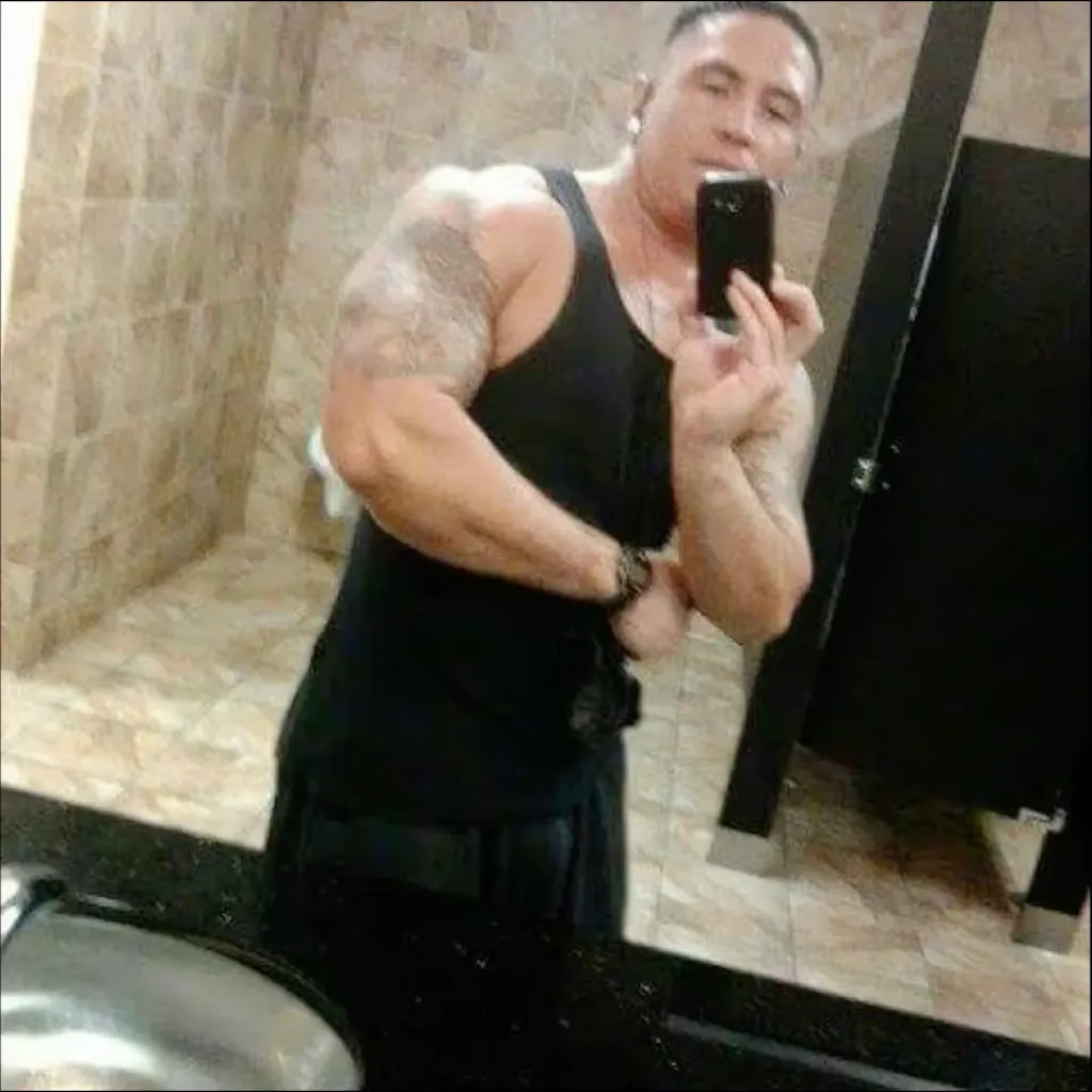 Man taking a selfie in a bathroom mirror.